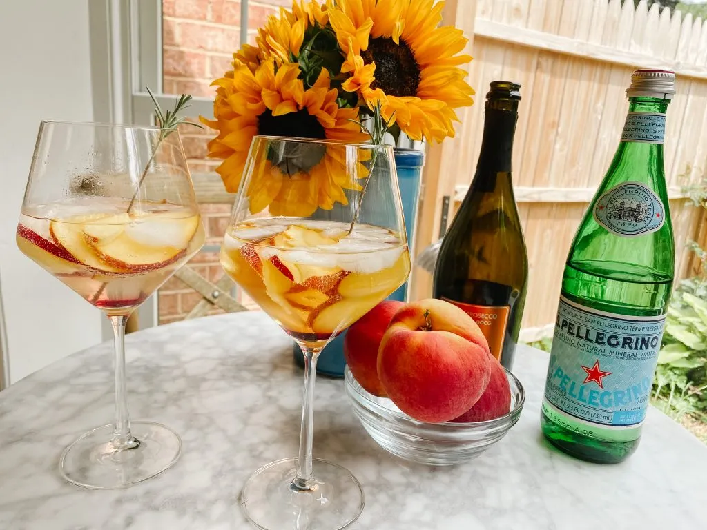 two glasses of Piscine Peche - sparkling wine, peaches and pellegrino