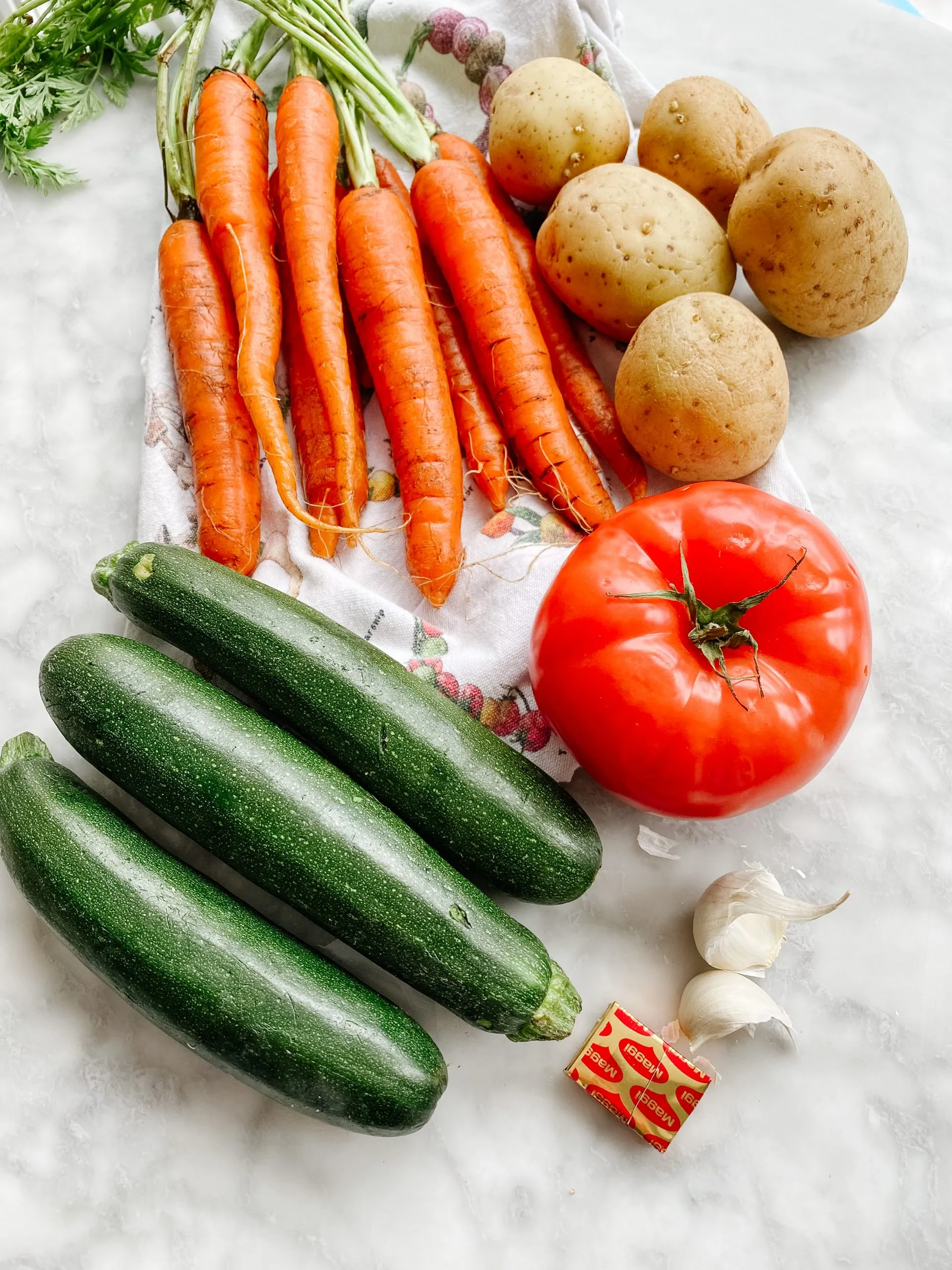 making Potage aux légumes ingredients: tomatoes, zucchini, potatoes, carrots, garlic and bouillon