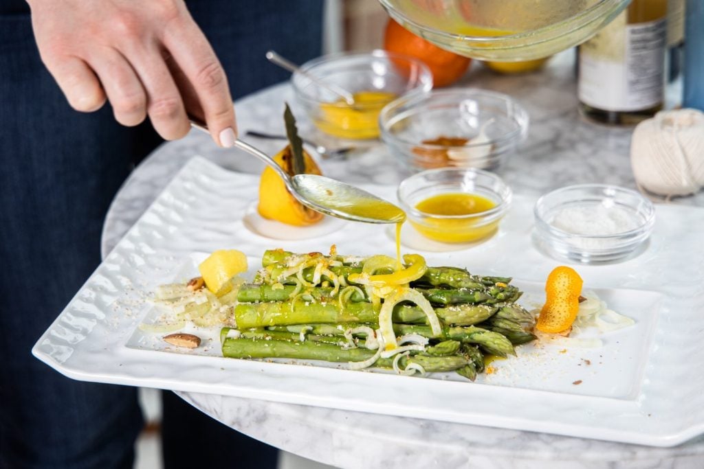 French Asparagus with a champagne citrus vinaigrette on a white plate