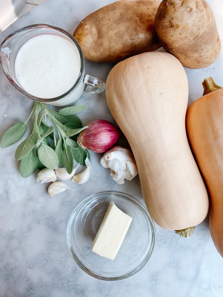 Ingredients for butternut squash soup with cream and sage on a table