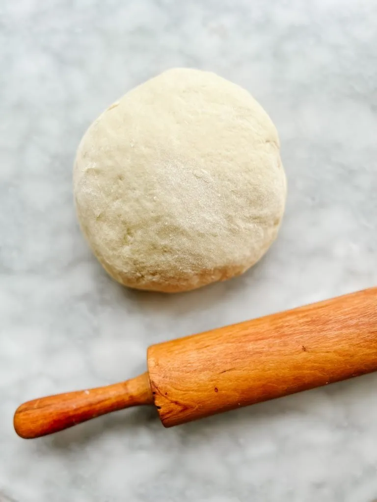 Dough ready to roll for La Pompe a l'huile with rolling pin