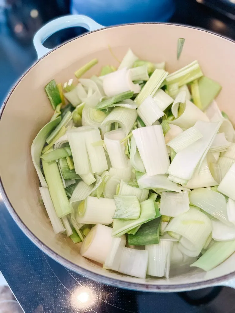Leeks chopped up in a soup pot