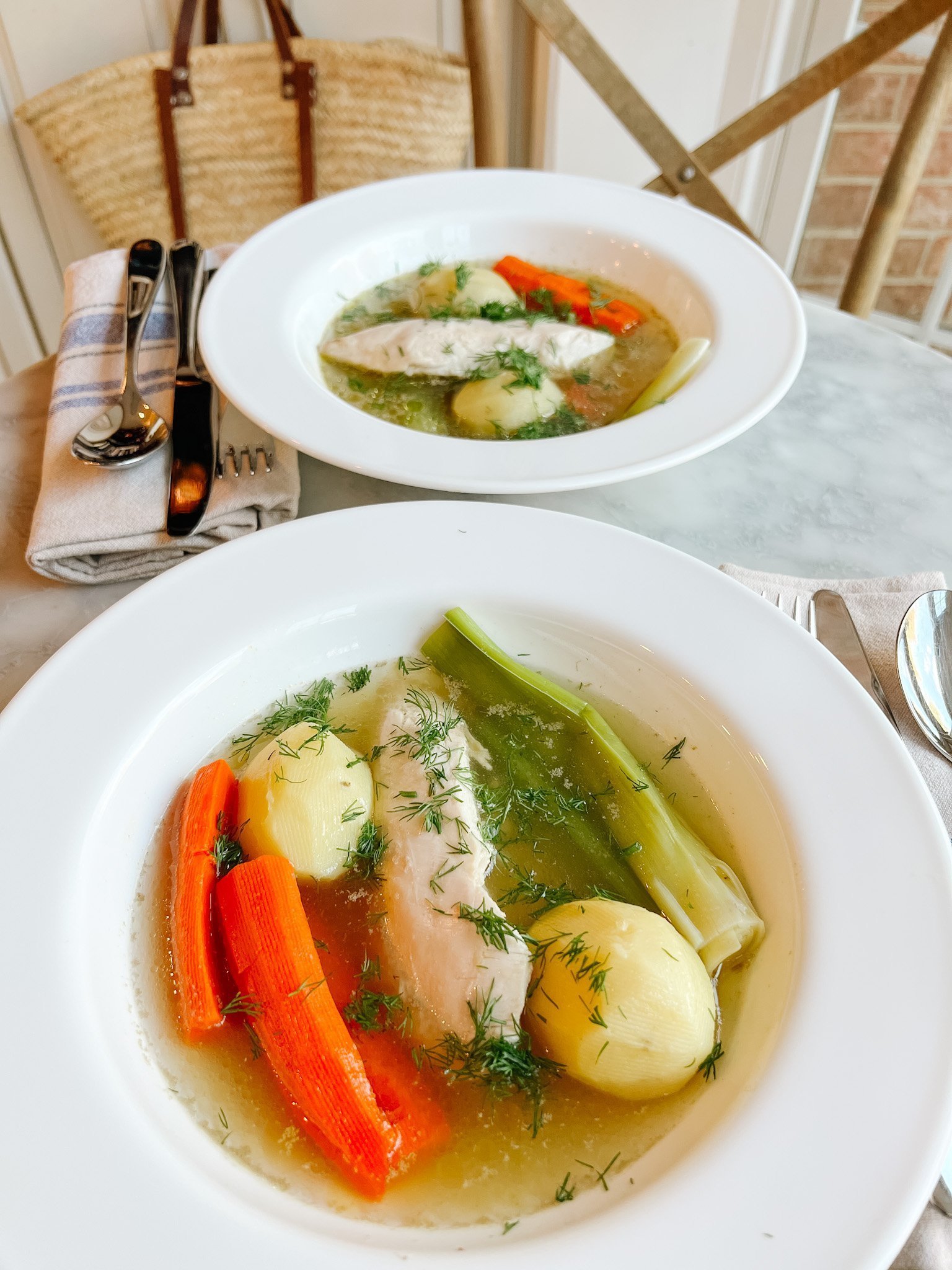 poule au pot - chicken with carrots and leeks and potatoes in broth with fresh dill