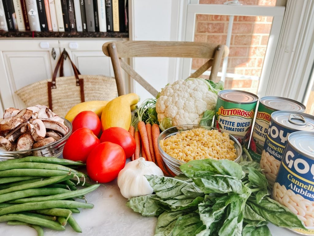 ingredients for Le Chef's Wife Minestrone - basil, pasta, green beans, tomatoes, squash, carrots, mushrooms, cauliflower