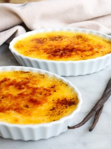 Crème Brulée on a table ready to eat with two spoons