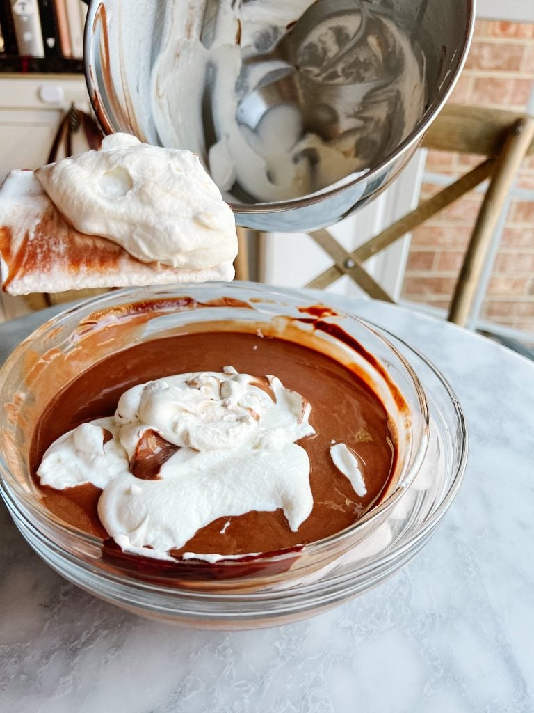 Mixing the whipped cream with the chocolate Crème Anglaise in a bowl