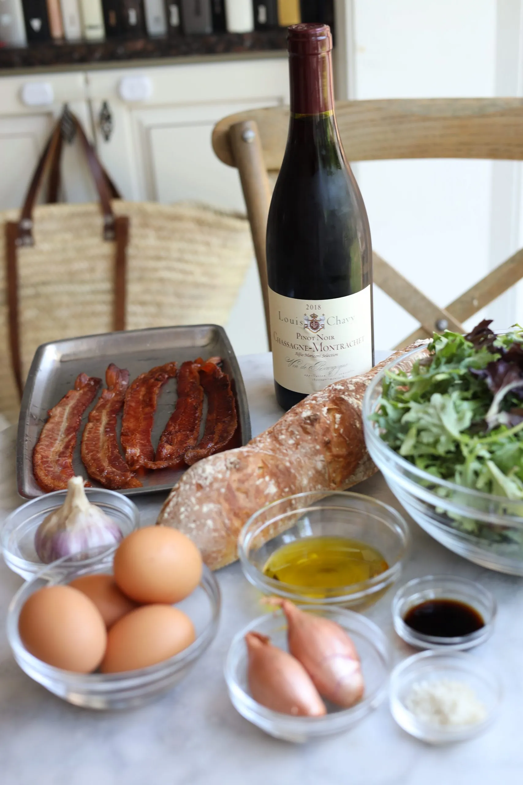 Ingredients for salade lyonnaise: bacon, garlic, eggs, red wine, shallots, french baguette, mixed greens