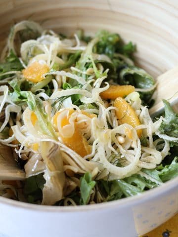 la salade mentonnaise : fennel, oranges, pine nuts, artichokes and greens in a serving bowl