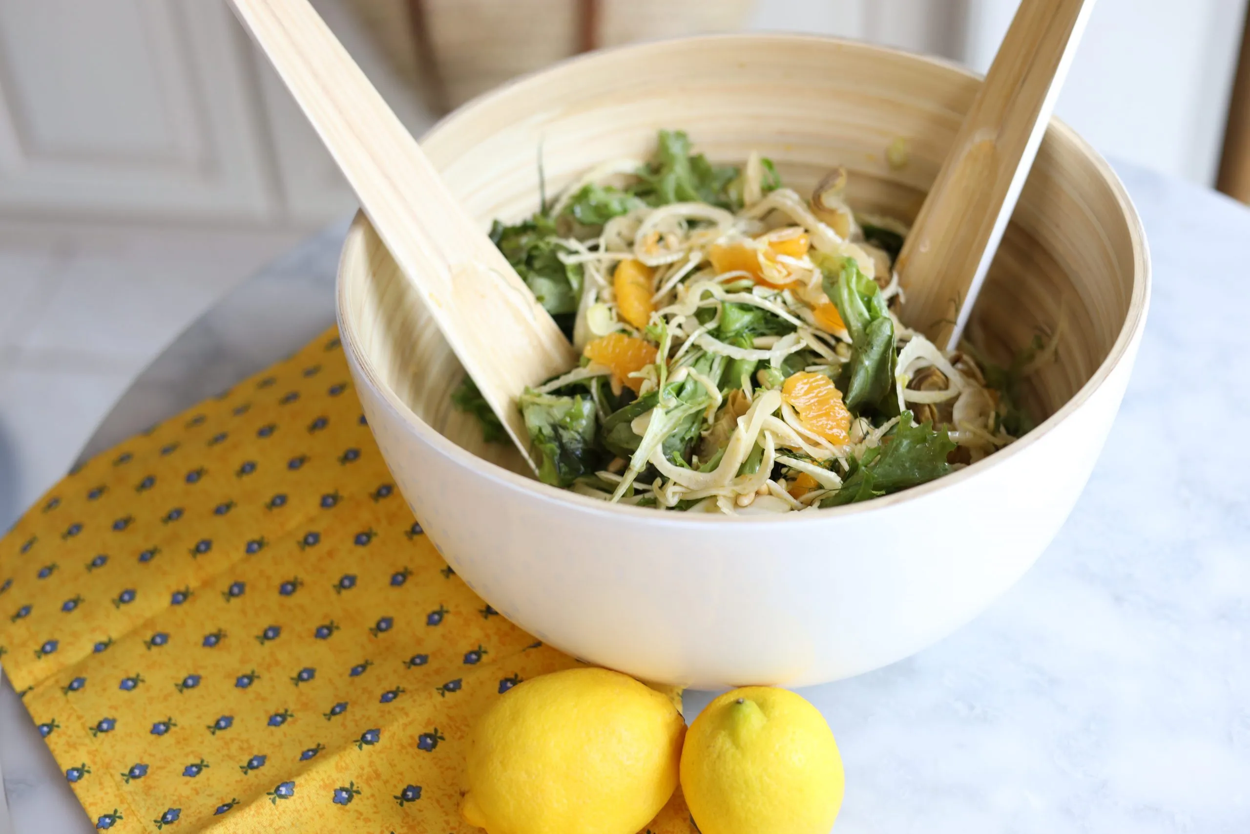 la salade mentonnaise : fennel, oranges, pine nuts, artichokes and greens in a serving bowl