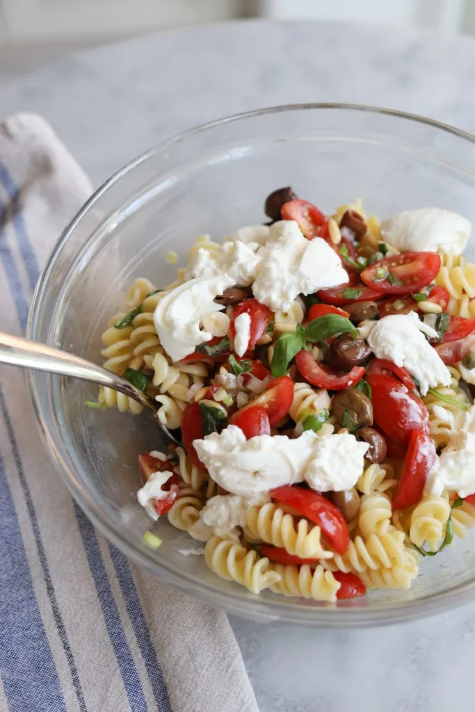 Sauce Vierge (tomatoes, olives, capers, basil, pine nuts, lemon) over pasta sald with Burrata