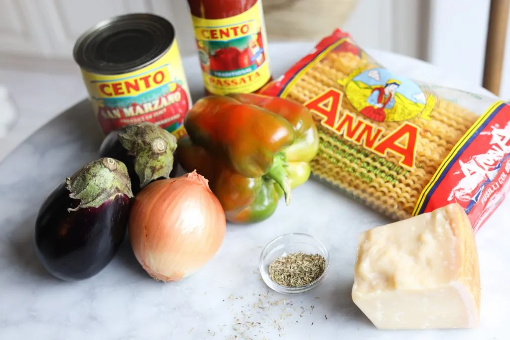 ingredients for Eggplant ragu - eggplant, onion, herbes de provence, canned tomato sauce, parmesan, fusilli col buco