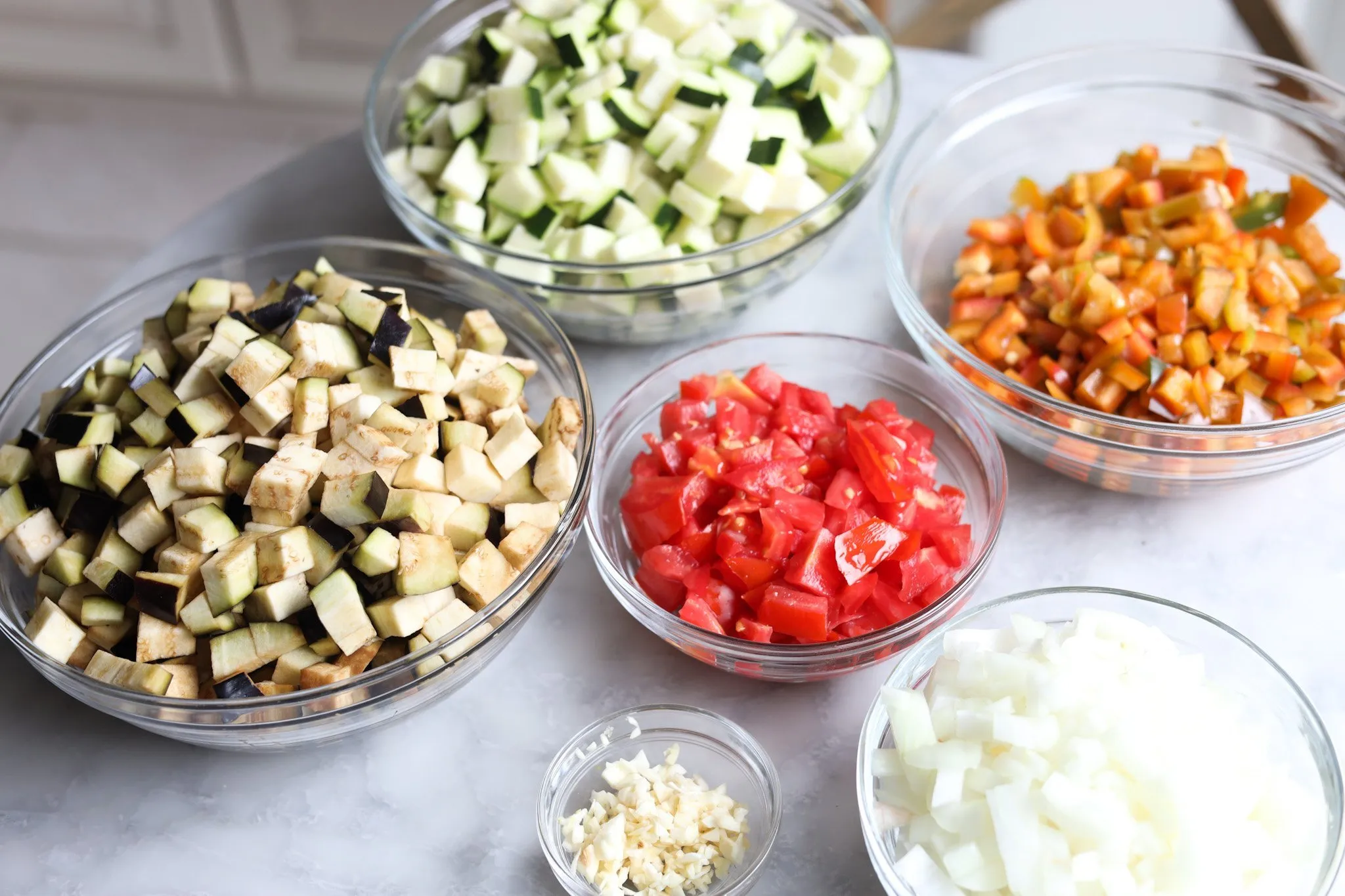 chopped ingredients for ratatouille - eggplant, zucchini, tomatoes, garlic, onion, pepper