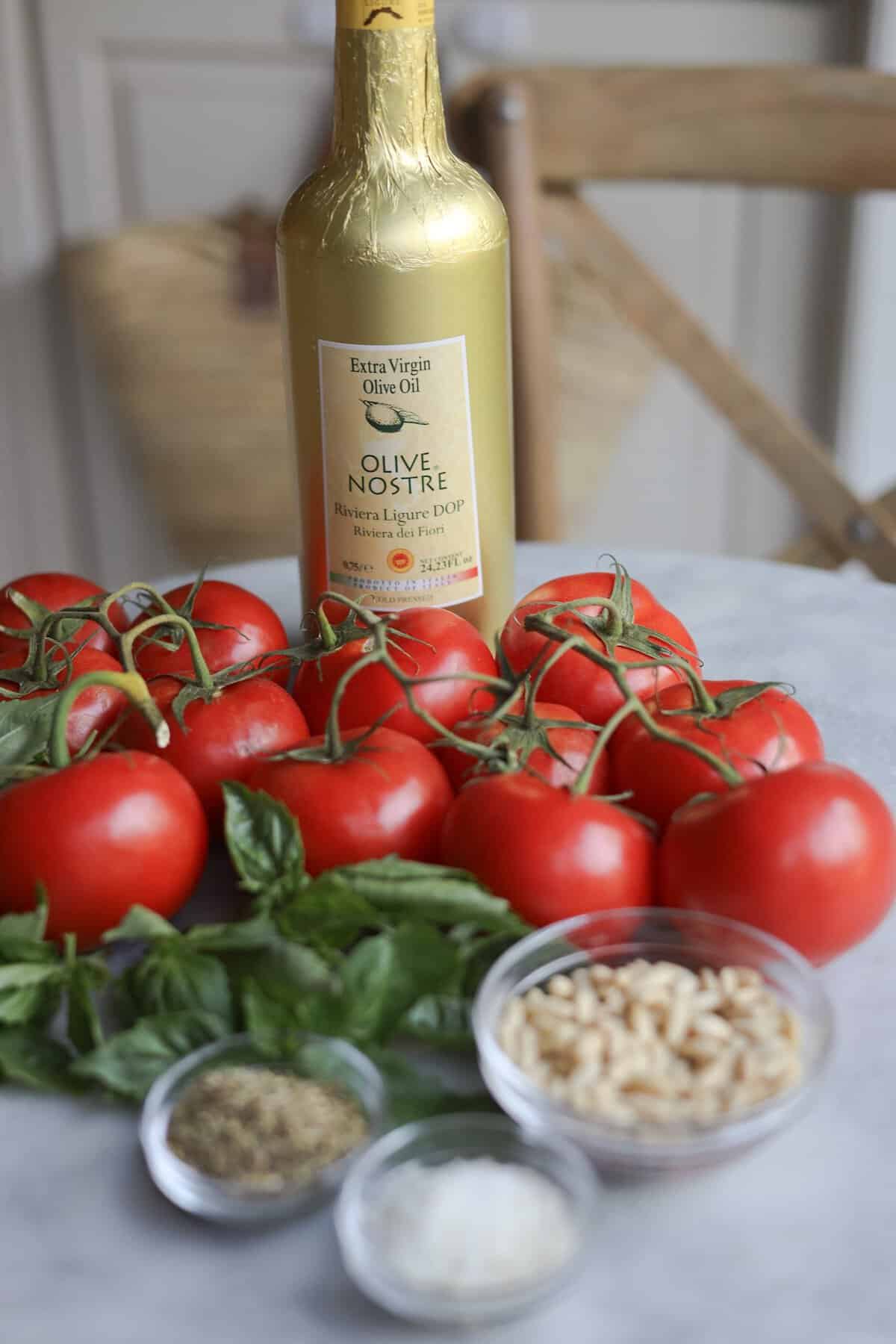 ingredients for tomatoes provenรงale - tomatoes, pine nuts, olive oil and herbes de provence