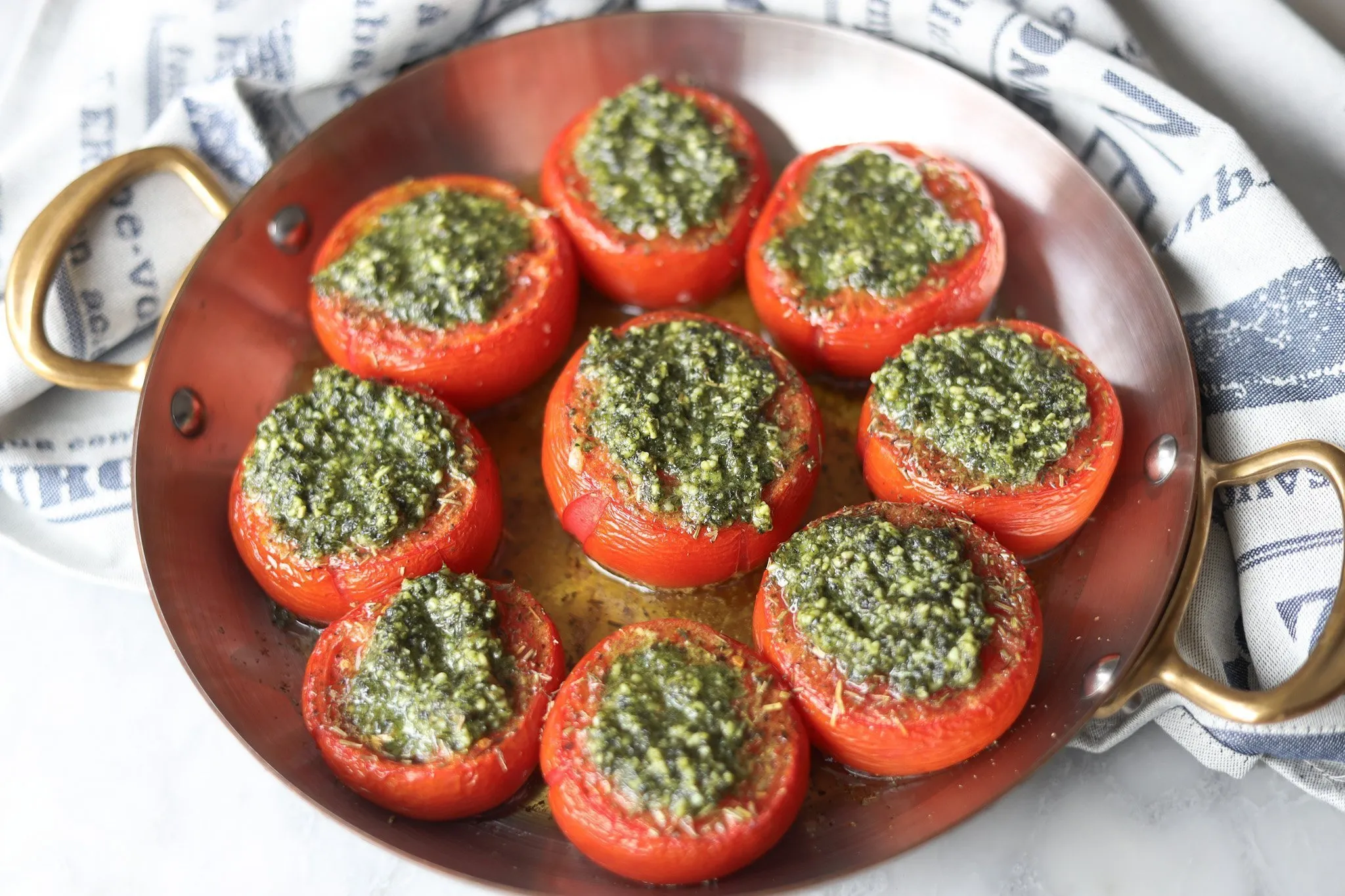 tomatoes Provençale with garlic pesto in a copper baking dish