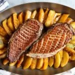duck magret in a pan with apples and squash
