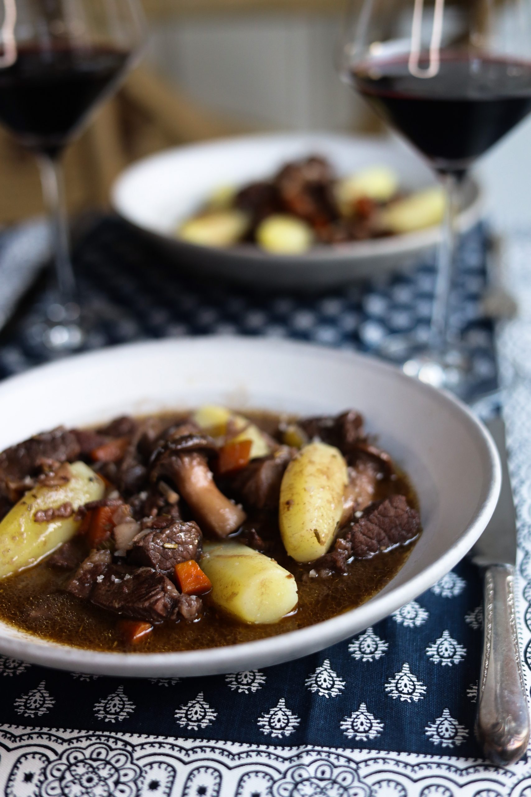 beef bourguignon in a plate with potatoes tournées