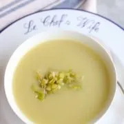 a bowl of leek soup with sauteed leeks as a garnish