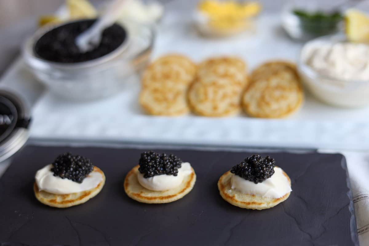 Caviar presentation on blinis with creme fraiche