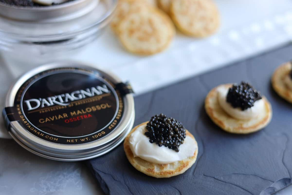 Caviar presentation on blinis with creme fraiche