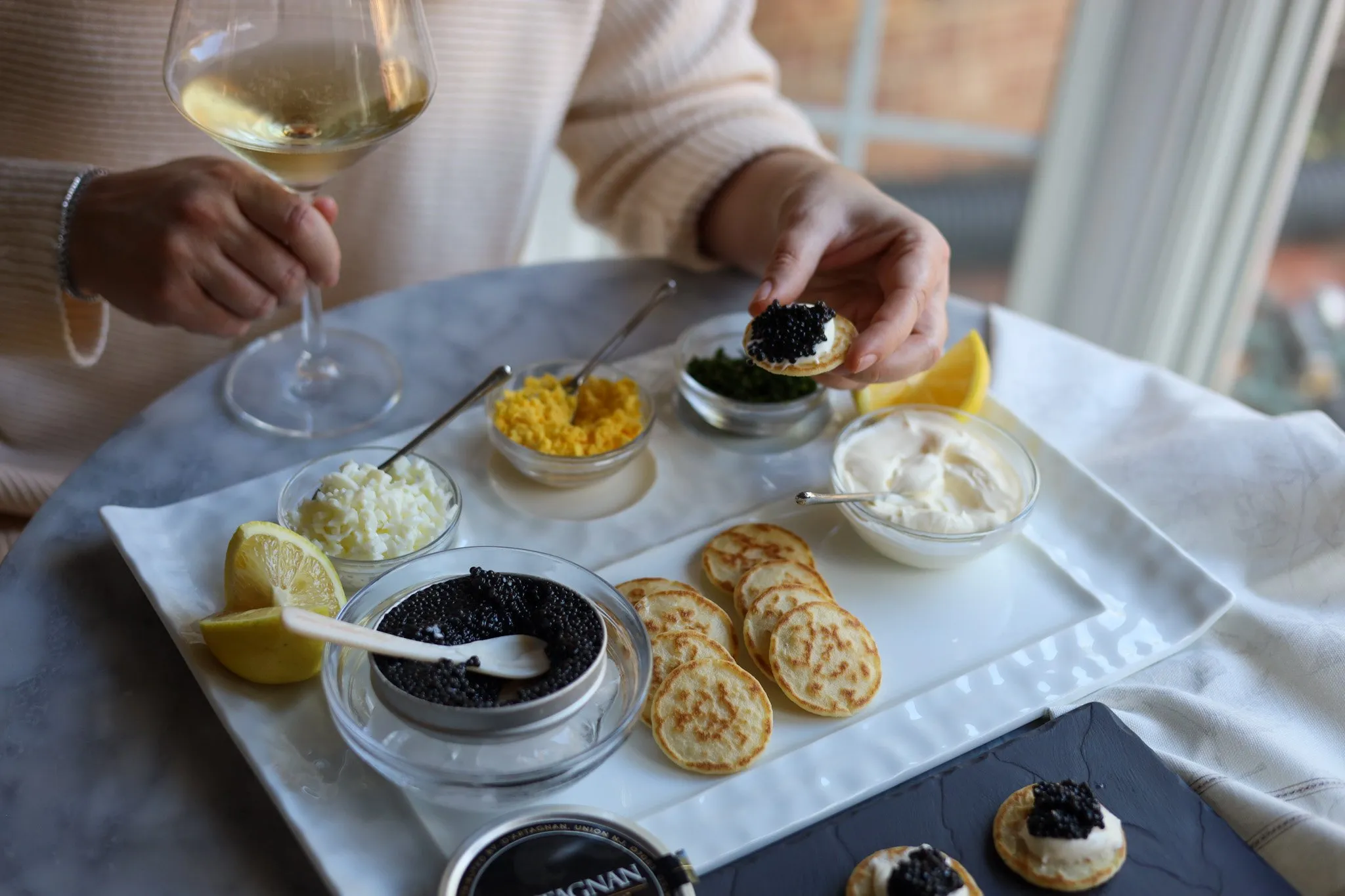 Caviar presentation on blinis with creme fraiche