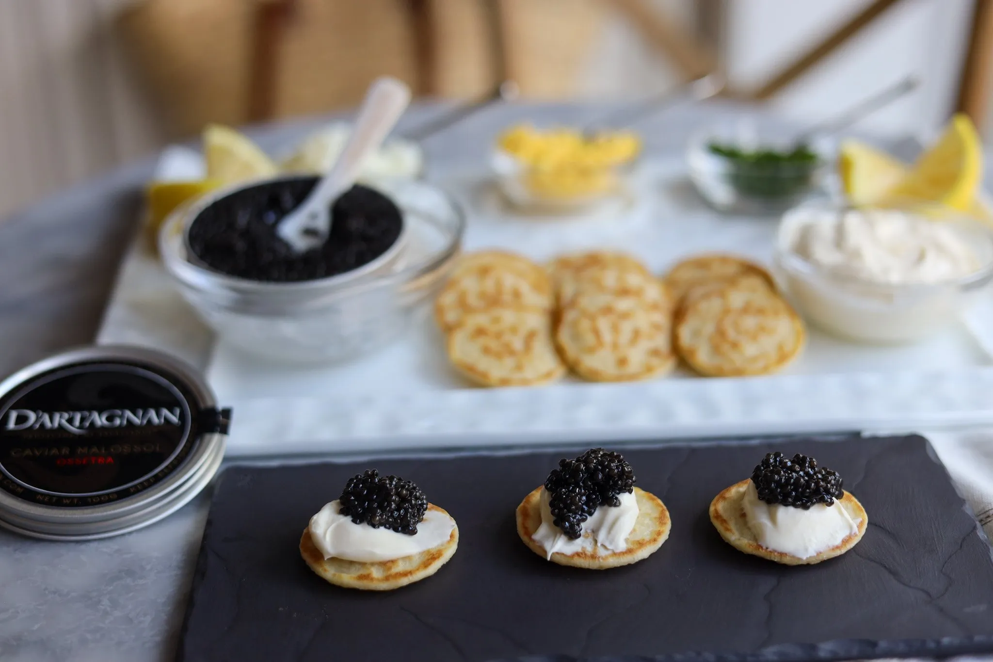 Caviar presentation on blinis with creme fraiche