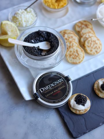 Caviar presentation on blinis with creme fraiche