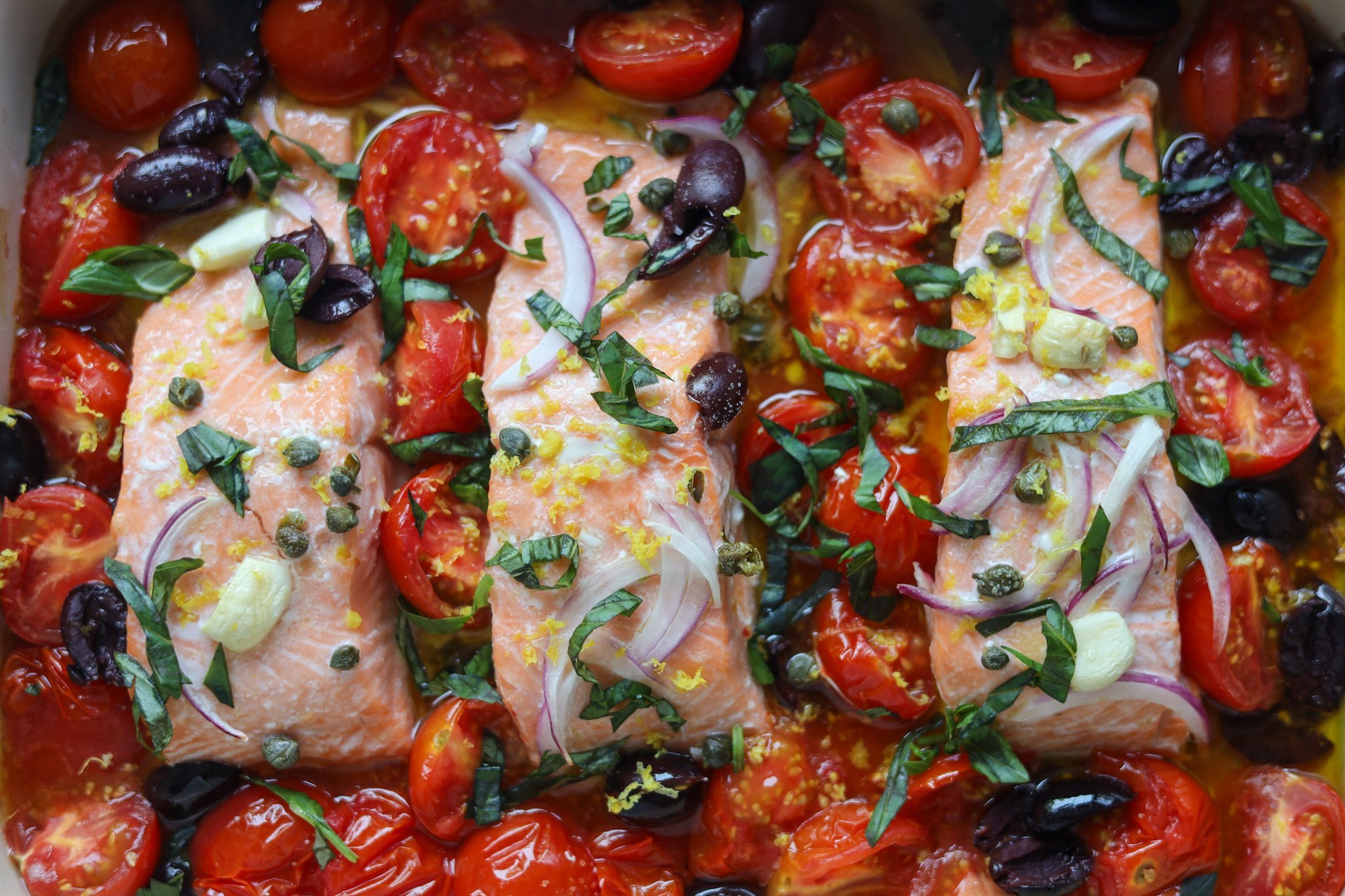 Mediterranean Salmon baked with tomatoes, garlic, basil, olives and capers