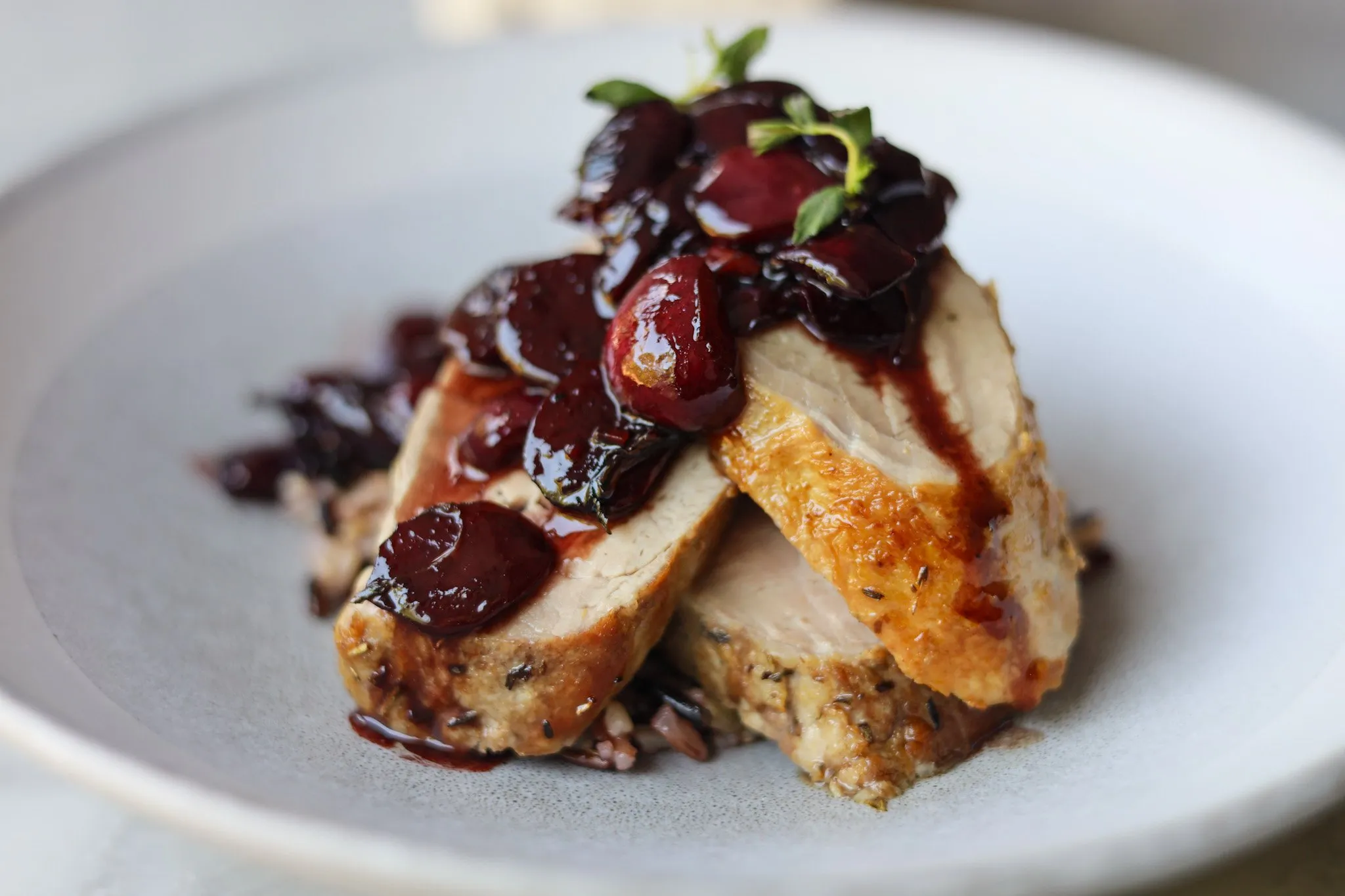 Pork tenderloin with cherry sauce finished dish for serving