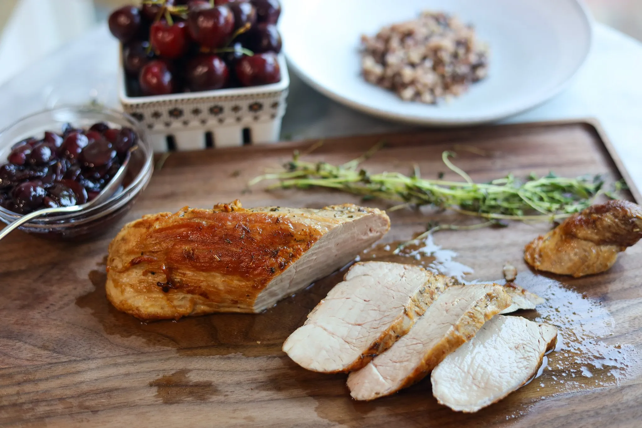 Pork tenderloin with cherry sauce on a cutting board