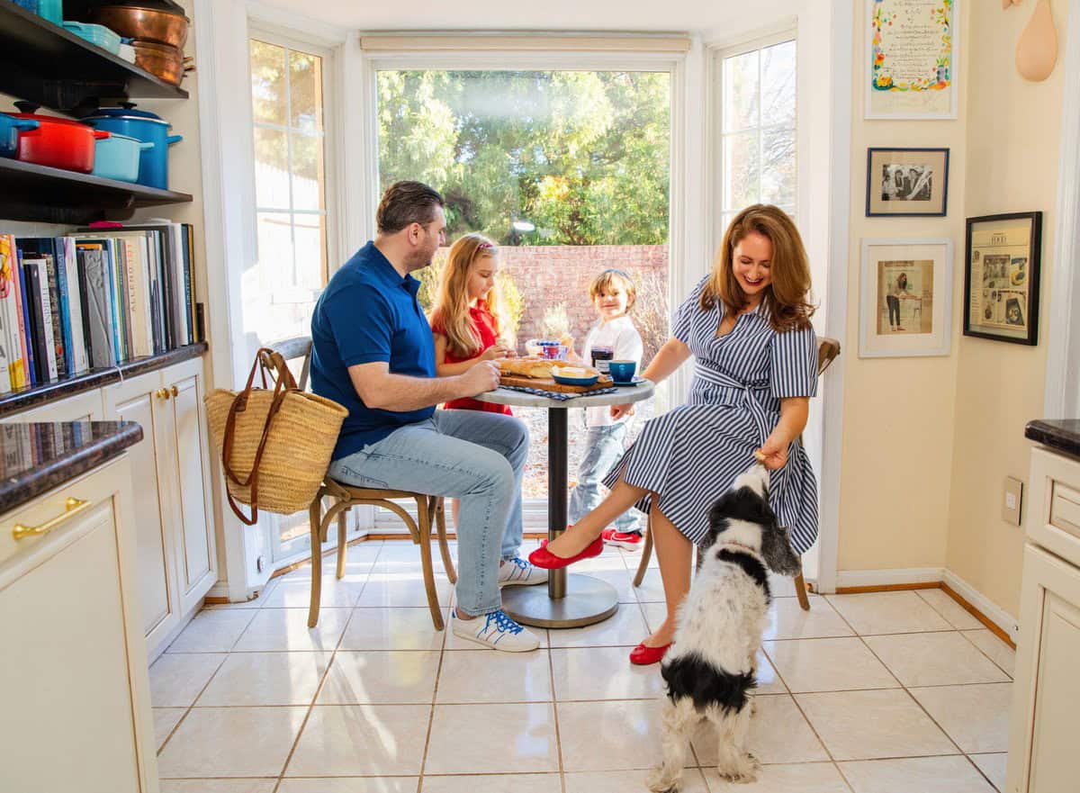 le chefs wife family sitting at the breakfast table enjoying breakfast with their dog