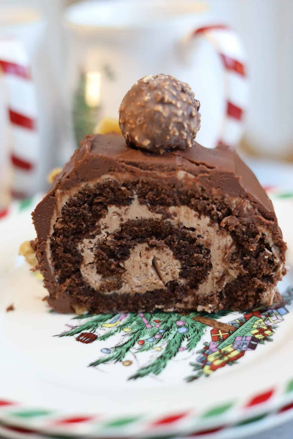 the inside of a nutella chocolate buche de noel caked sliced open you can see the perfect swirl of nutella buttercream inside the chocolate cake