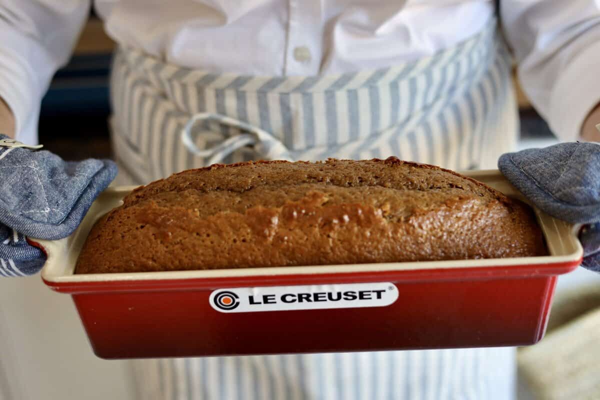 close up of gingerbread spice cake risen in a le creuset terrine held by le chefs wife in her kitchen