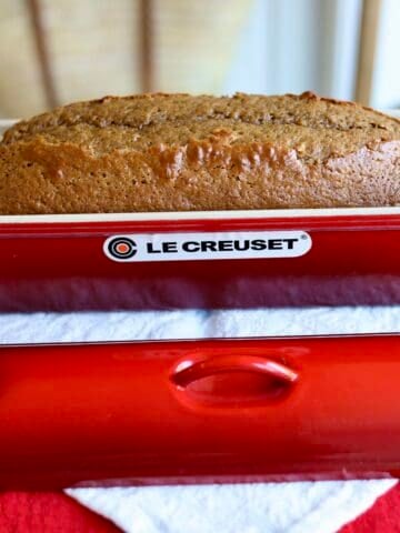 close up of gingerbread spice cake risen in a le creuset terrine on a holiday napkin in le chefs wife kitchen.