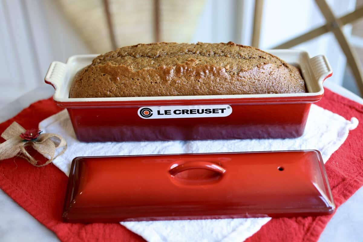 close up of gingerbread spice cake risen in a le creuset terrine on a holiday napkin in le chefs wife kitchen.