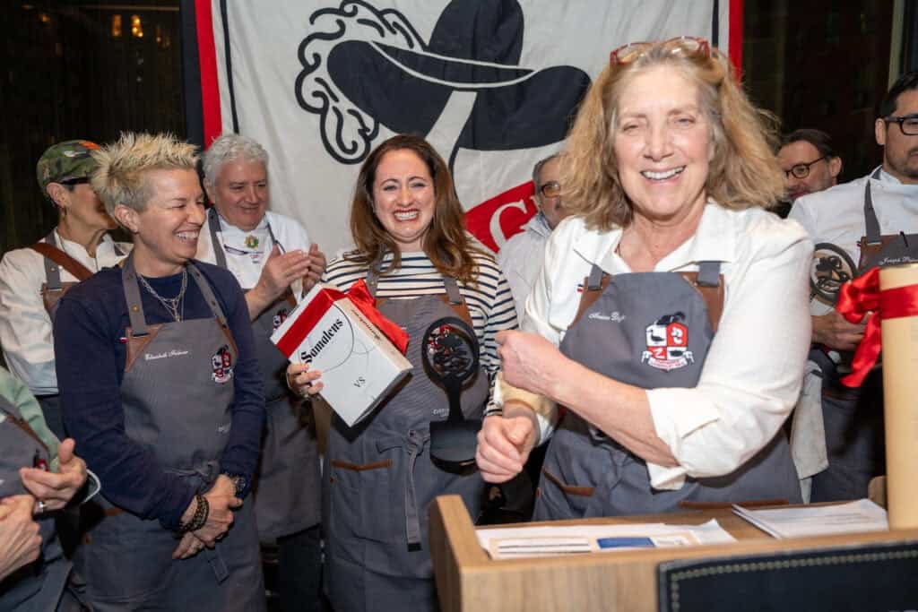 Dartagnan foods cassoulet war cooking competition winners on stage including le chefs wife with her award. judges Elizabeth Falkner and Ariane Daguin