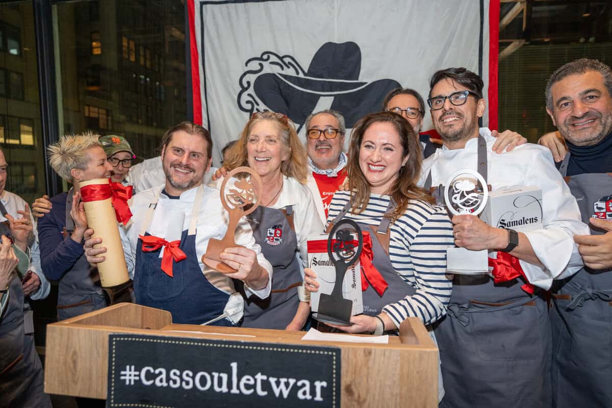 Dartagnan foods cassoulet war cooking competition winners on stage including le chefs wife with her award.