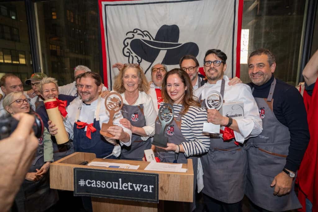 Dartagnan foods cassoulet war cooking competition winners on stage including le chefs wife with her award.