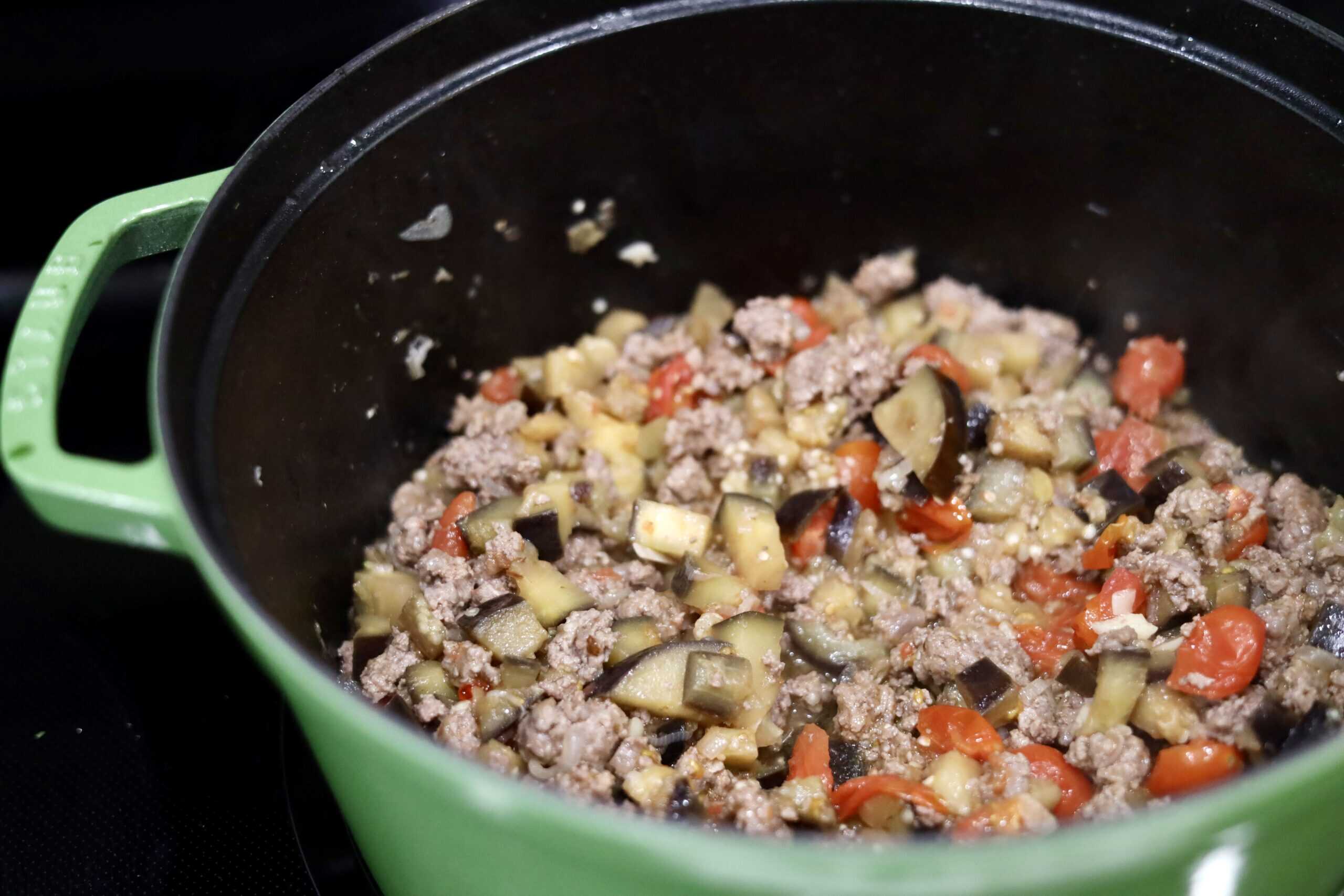 ingredients for eggplant, pistachio, ground lamb, and pomegranate seed rice in a dutch oven