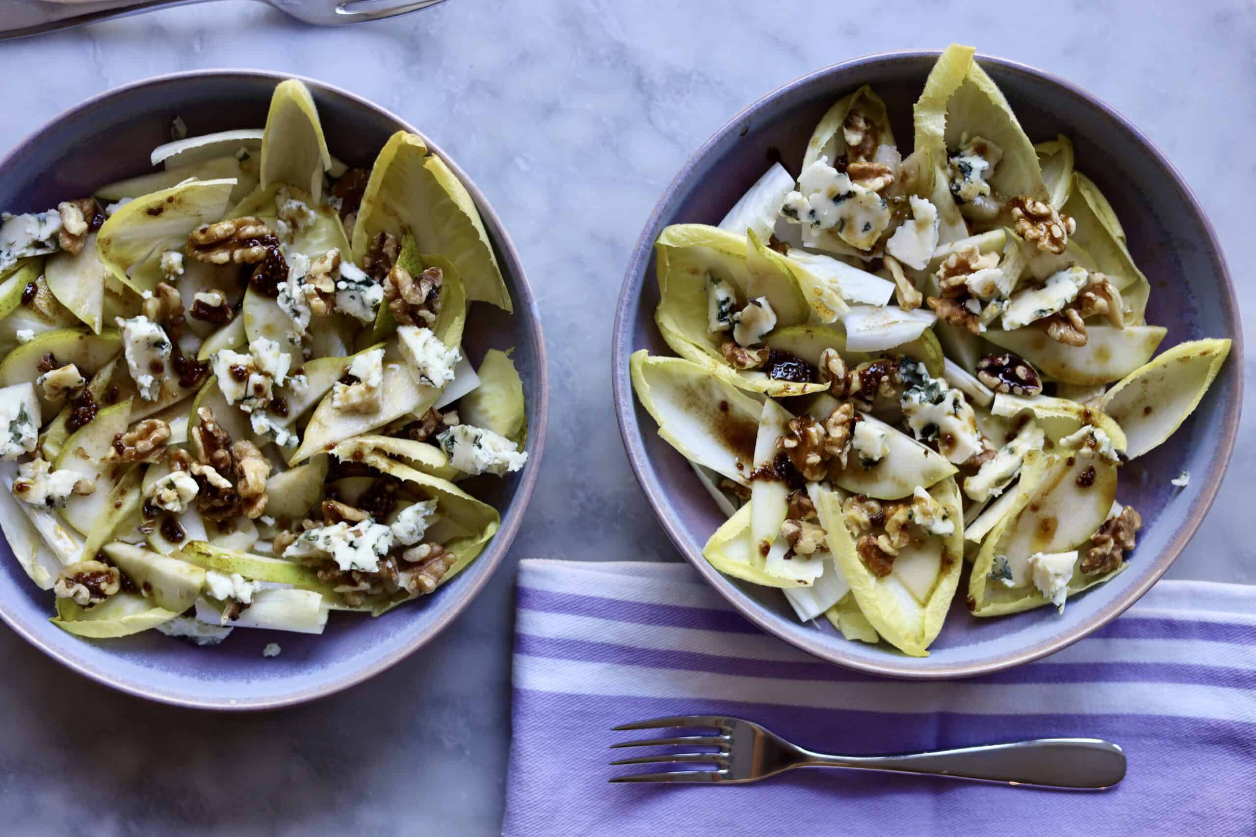 close up of classic endive salad with blue cheese, endives, walnuts, pears and dijon mustard