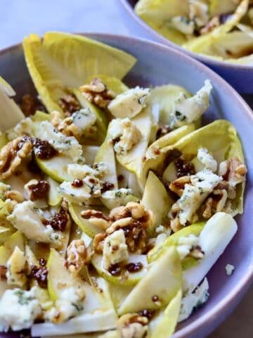 close up of classic endive salad with blue cheese, endives, walnuts, pears and dijon mustard