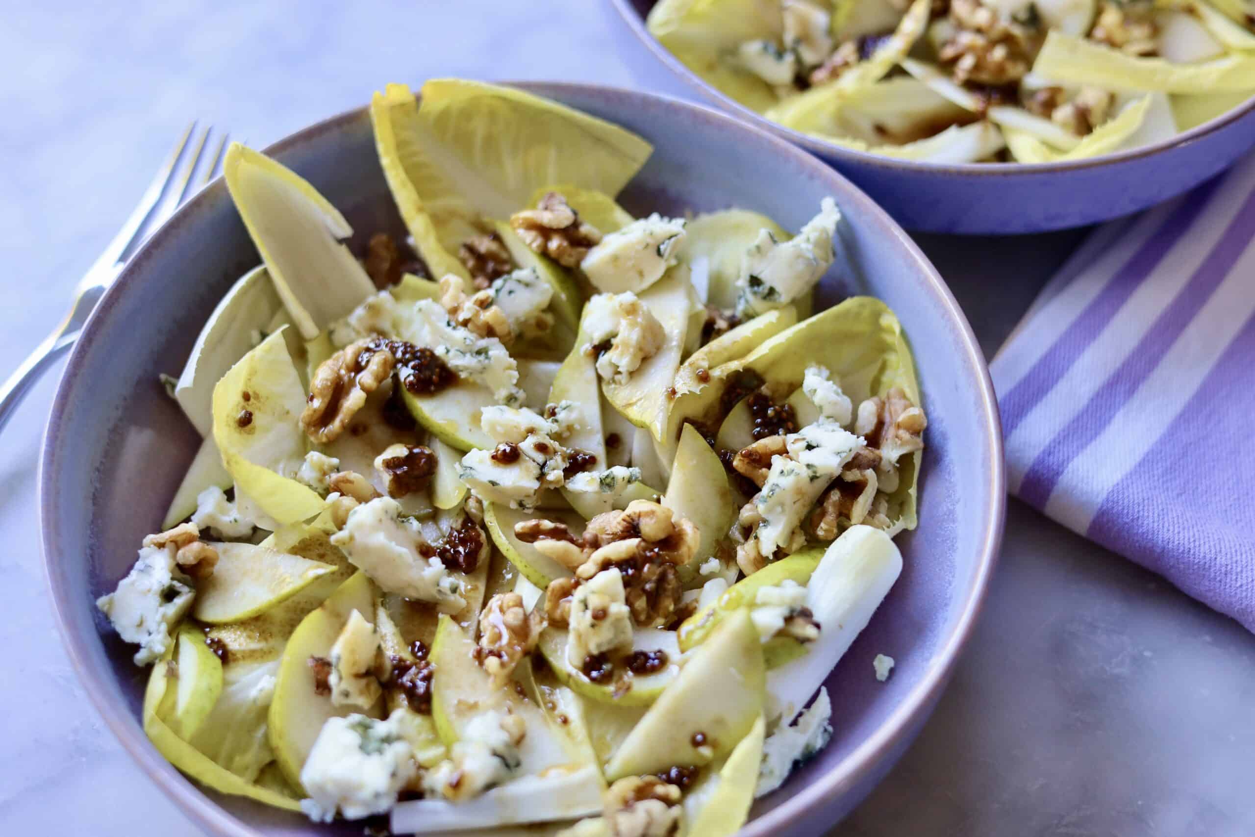 close up of classic endive salad with blue cheese, endives, walnuts, pears and dijon mustard