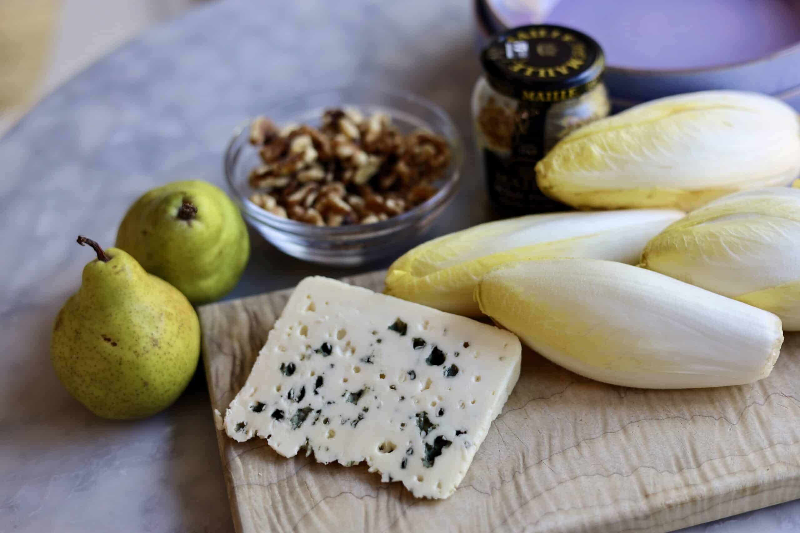 classic endive salad ingredients with blue cheese, endives, walnuts, pears and dijon mustard