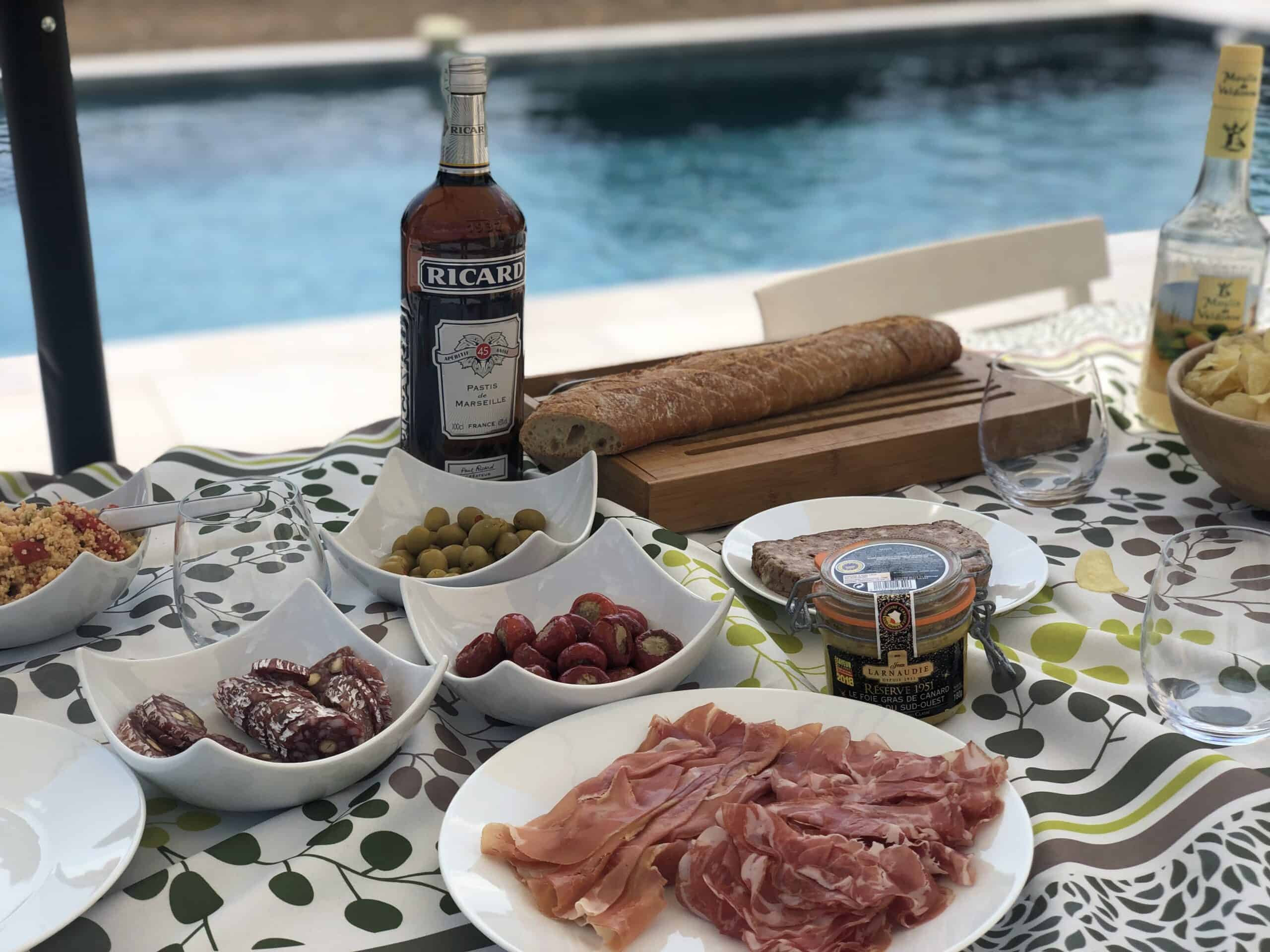 apero next to the pool in provence. taboulรฉ, saucisson, olives, foie gras , tapenade pastis